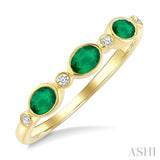 4X3 MM Oval Shape Emerald and 1/20 Ctw Bezel Set Round Cut Diamond Precious Fashion Band in 10K Yellow Gold