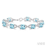 7x7 MM Cushion Shape Blue Topaz and 1/20 Ctw Round Cut Diamond Fashion Bracelet in Sterling Silver